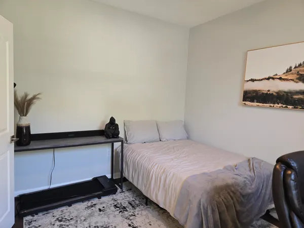 a bedroom with a bed and a dresser in it