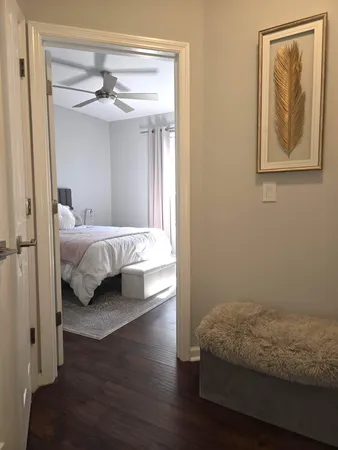 a bedroom with a bed and a painting on the wall