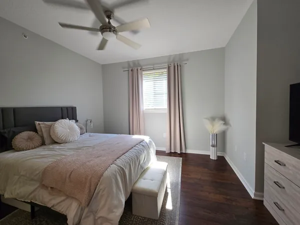 a bedroom with a bed and a flat screen tv