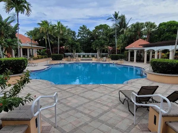 a swimming pool with outdoor seating and yard