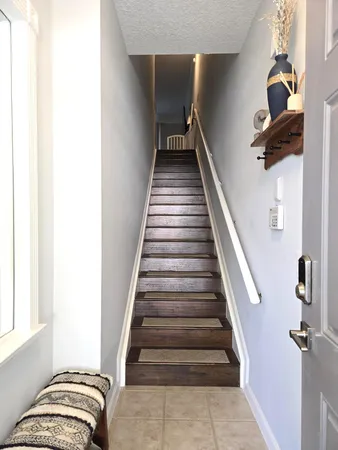 a view of entryway and hall with wooden floor