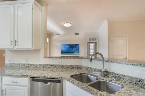 a kitchen with granite countertop a sink and a granite counter tops