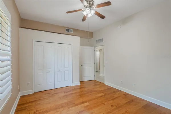 a view of empty room with wooden floor