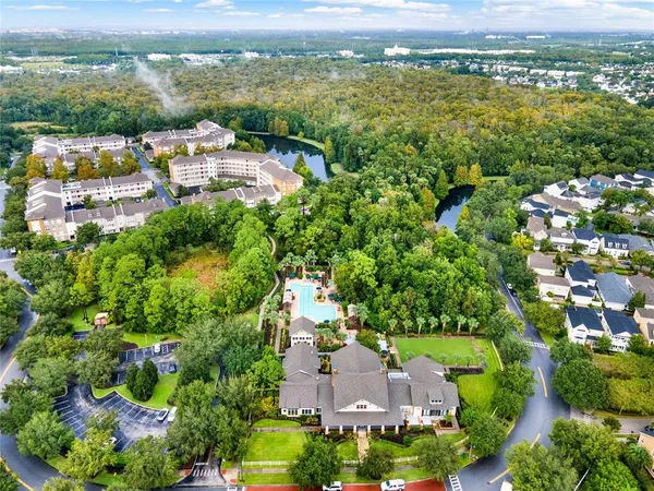 an aerial view of residential houses with outdoor space and river