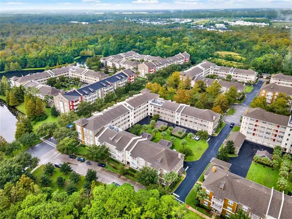 an aerial view of residential houses with outdoor space