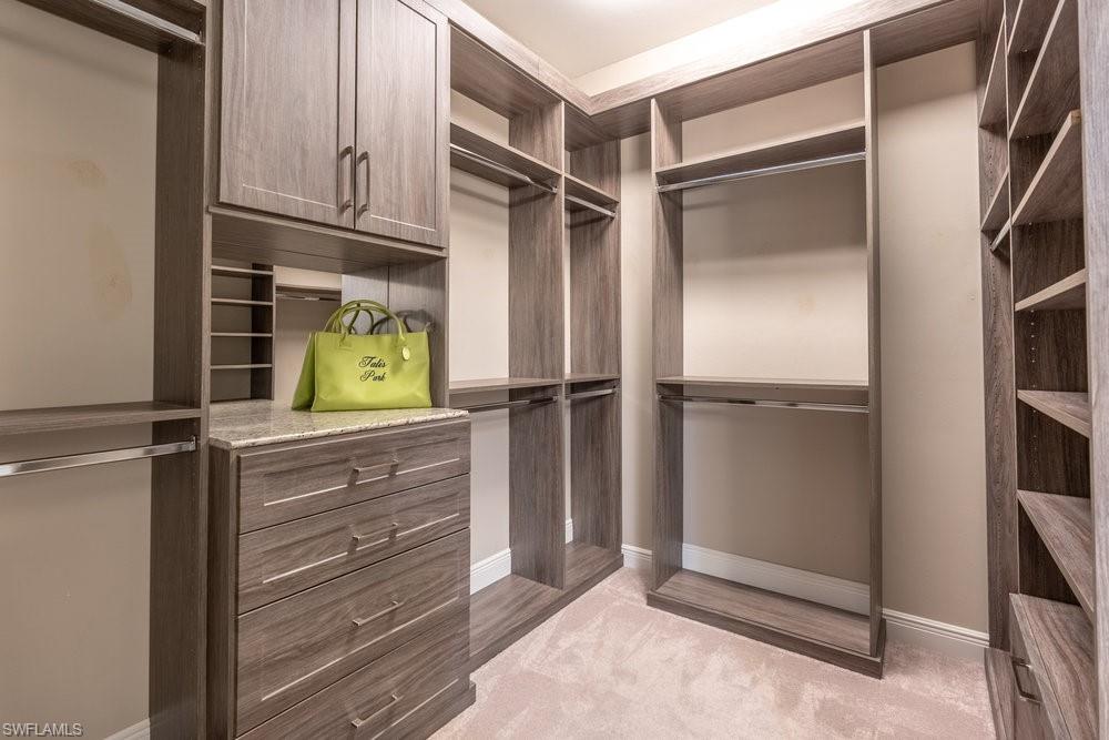 16444 Carrara Way, Unit 7301 Naples, FL 34110 - Photo 19 of 42 a kitchen with appliances and cabinets