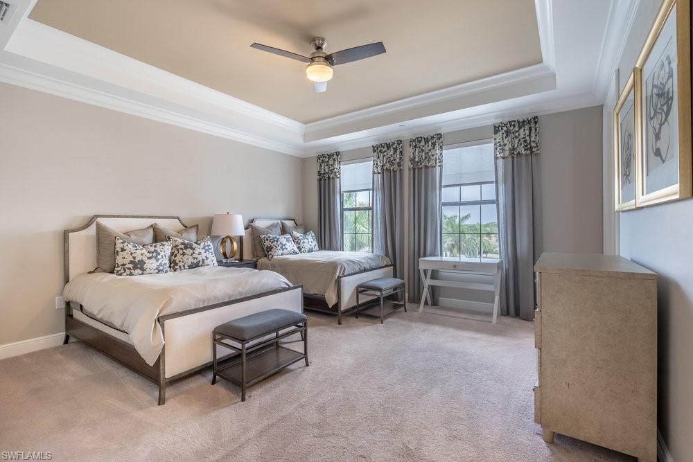 16444 Carrara Way, Unit 7301 Naples, FL 34110 - Photo 24 of 42 a spacious bedroom with a bed and a couch