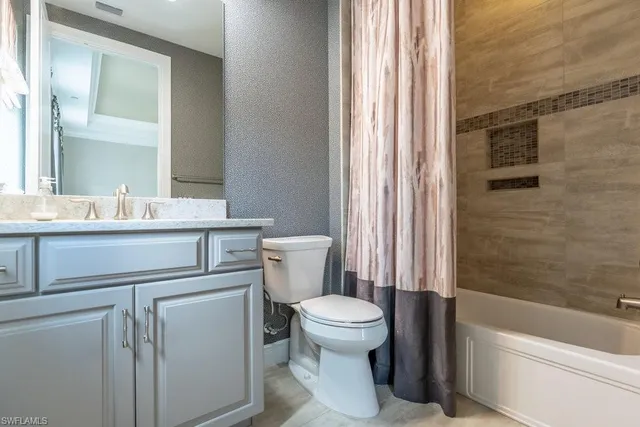 a bedroom with a bed lamp and window