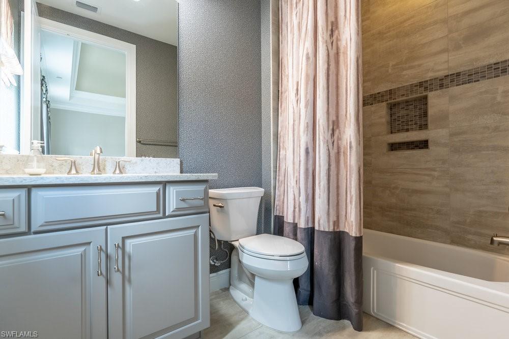 16444 Carrara Way, Unit 7301 Naples, FL 34110 - Photo 25 of 42 a bathroom with a sink a toilet a mirror and shower