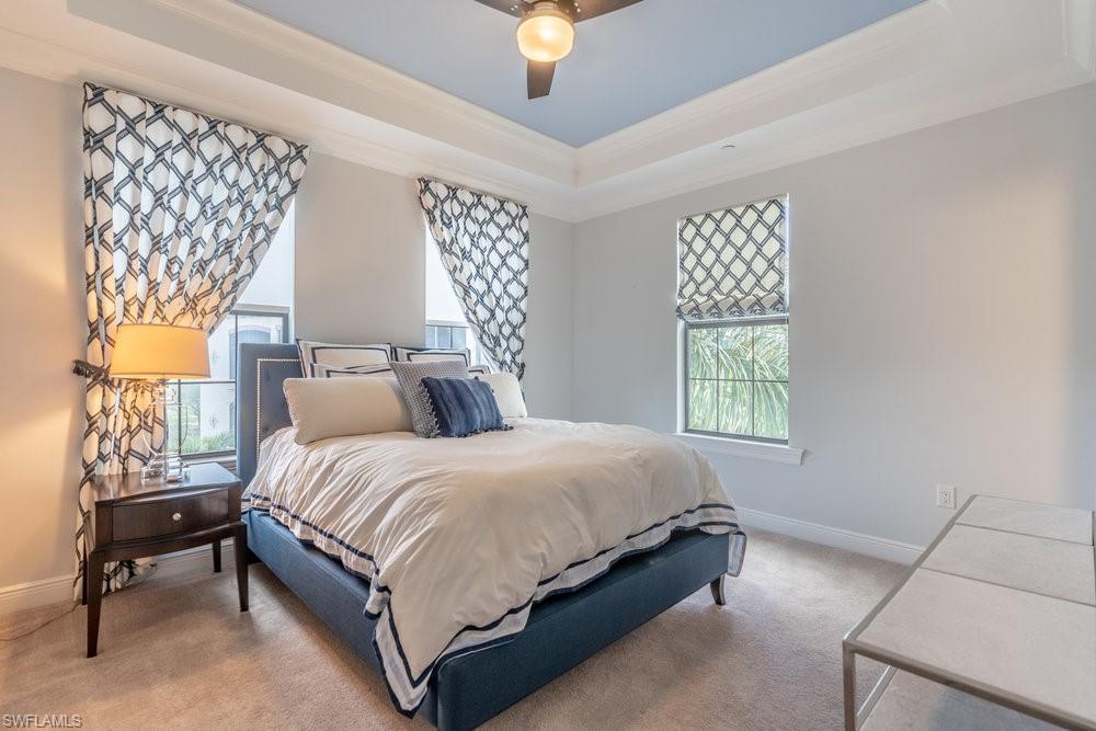 16444 Carrara Way, Unit 7301 Naples, FL 34110 - Photo 26 of 42 a bedroom with a bed lamp and window