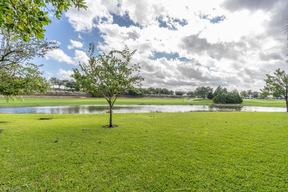 16444 Carrara Way, Unit 7301 Naples, FL 34110 - Photo 29 of 42 a view of an ocean and a yard