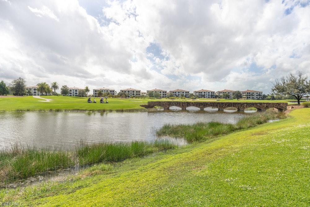 16444 Carrara Way, Unit 7301 Naples, FL 34110 - Photo 31 of 42 a view of a lake with a big yard