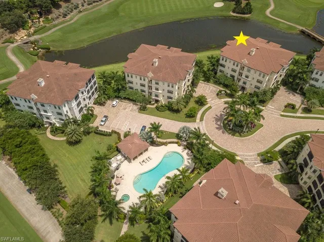 an aerial view of a house with a lake view