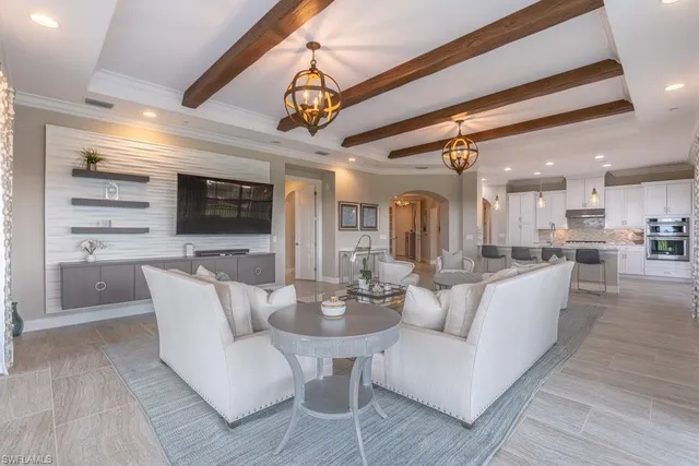 a large white kitchen with a large window and stainless steel appliances