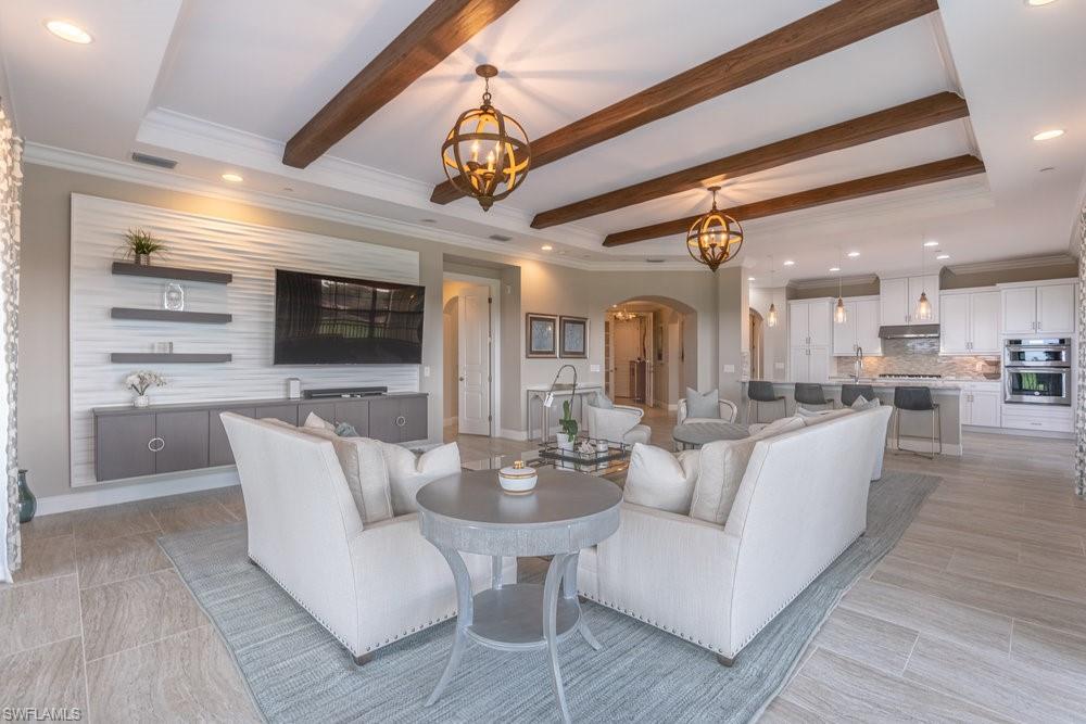 16444 Carrara Way, Unit 7301 Naples, FL 34110 - Photo 7 of 42 a large white kitchen with a large window and stainless steel appliances
