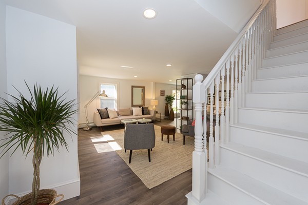 26 Vinal Avenue, Unit 1 Somerville, MA 02143 - Photo 11 of 17 a living room with furniture potted plant and a table