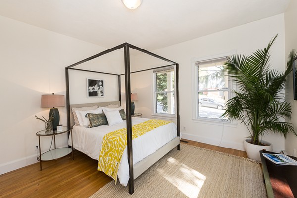 26 Vinal Avenue, Unit 1 Somerville, MA 02143 - Photo 14 of 17 a bedroom with a bed and a potted plant