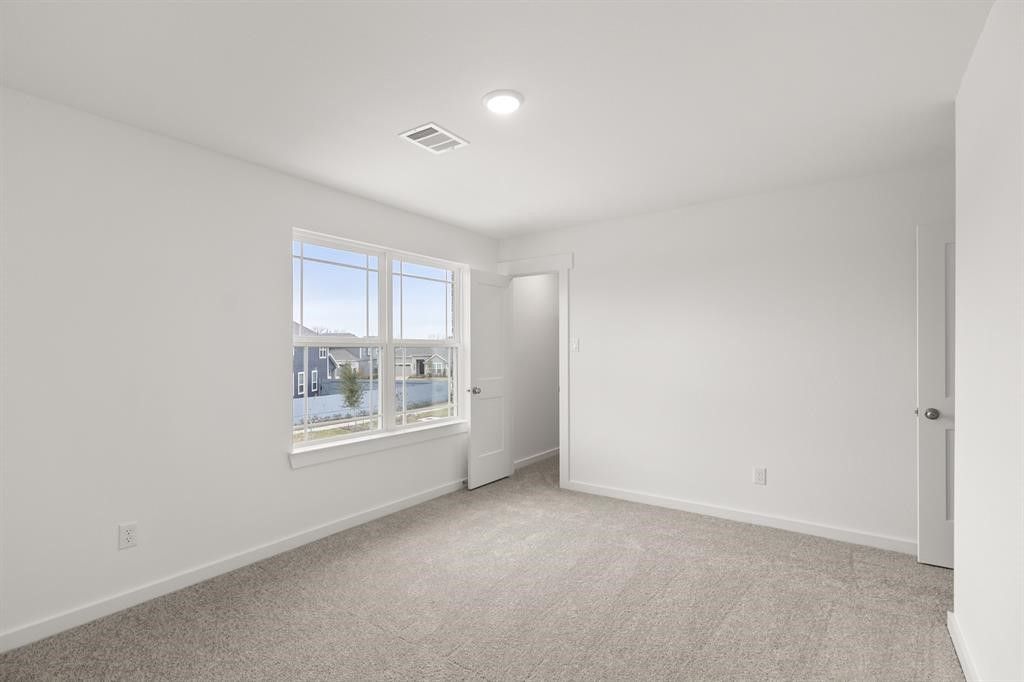 8239 Red Shiner Way Fulshear, TX 77441 - Photo 14 of 25 an empty room with windows