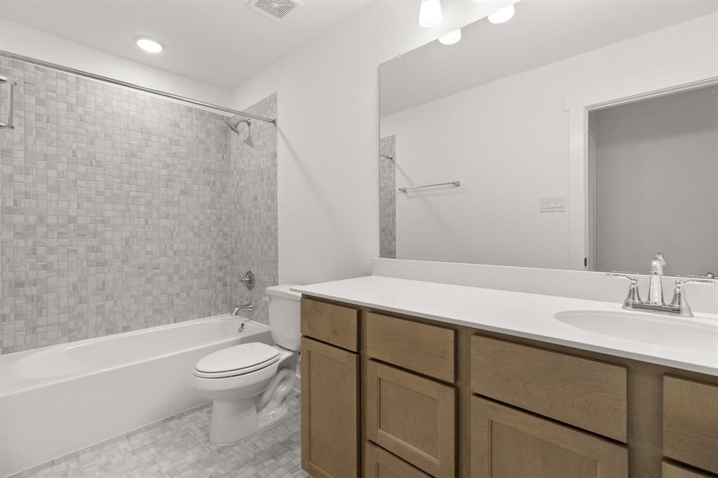 8239 Red Shiner Way Fulshear, TX 77441 - Photo 15 of 25 a bathroom with a sink toilet vanity and shower