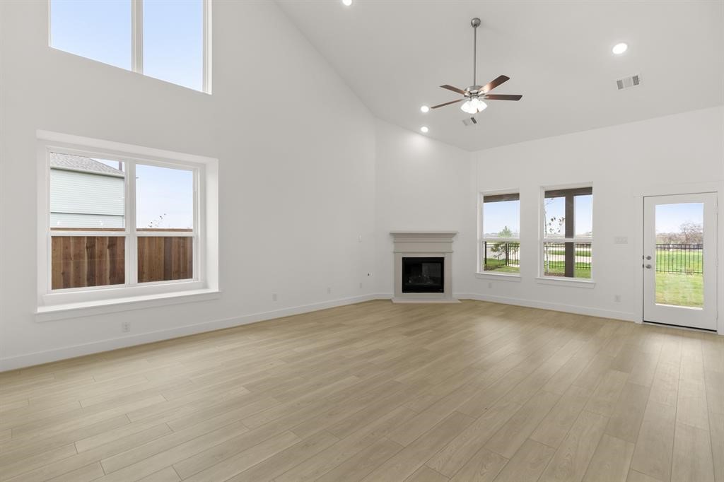 8239 Red Shiner Way Fulshear, TX 77441 - Photo 4 of 25 a view of an empty room with window and wooden floor
