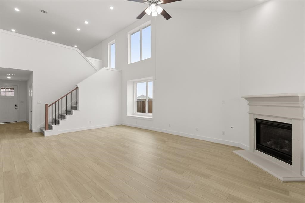 8239 Red Shiner Way Fulshear, TX 77441 - Photo 5 of 25 an empty room with windows and fireplace