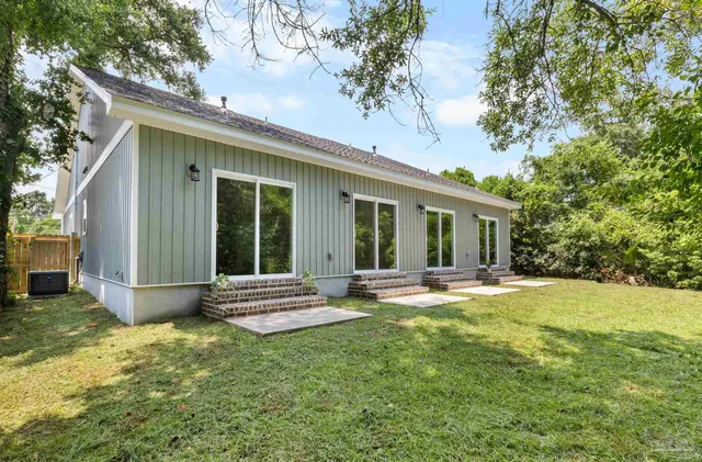 a view of a house with a yard and sitting area