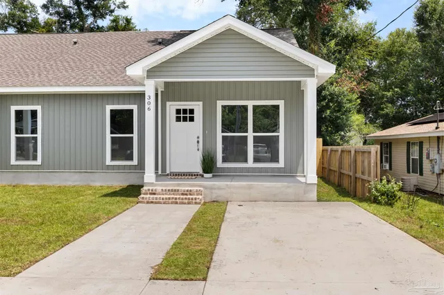 a view of house with backyard and garden