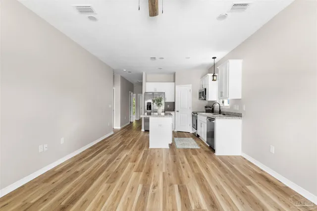 a view of a kitchen with wooden floor