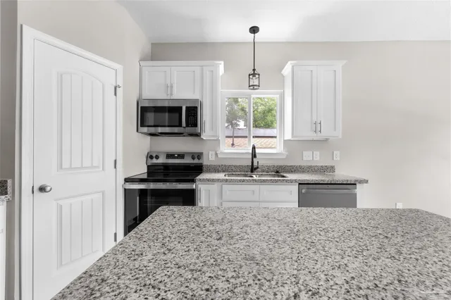 a kitchen with a stove and a sink