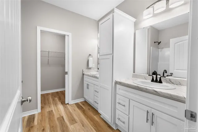 a spacious bathroom with a double vanity sink and mirror