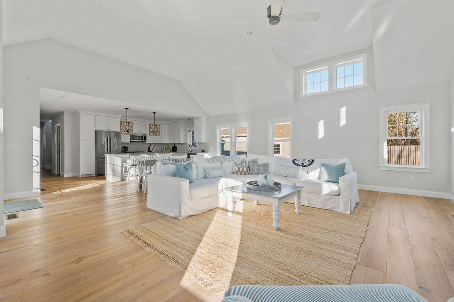 39 Cottage Lane Mashpee, MA 02649 - Photo 11 of 35 a living room with couches and kitchen view with wooden floor