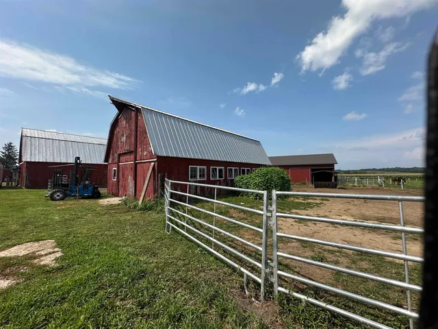 a view of backyard with deck and outdoor seating