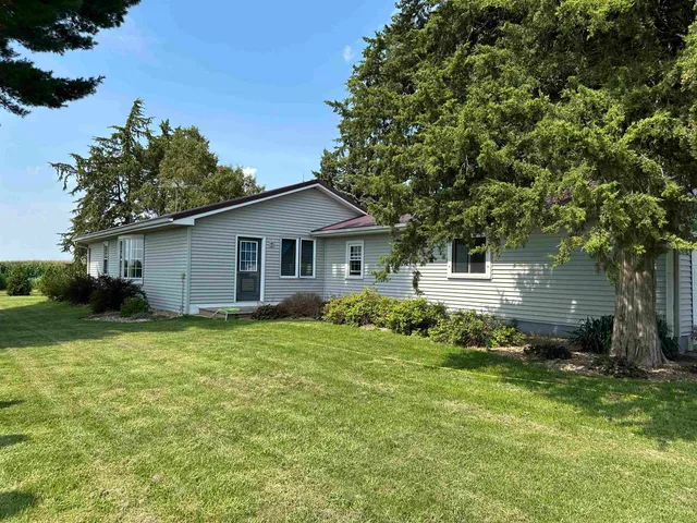 a view of a house with a backyard