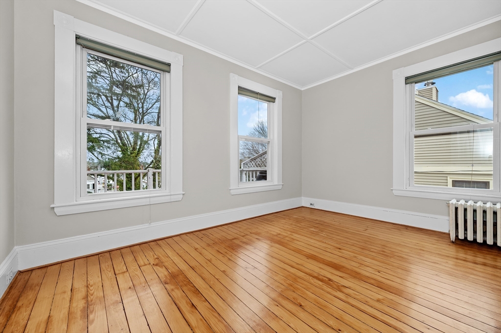 18 Bennett Street, Unit 2 Manchester, MA 01944 - Photo 15 of 21 a view of an empty room with wooden floor and a window