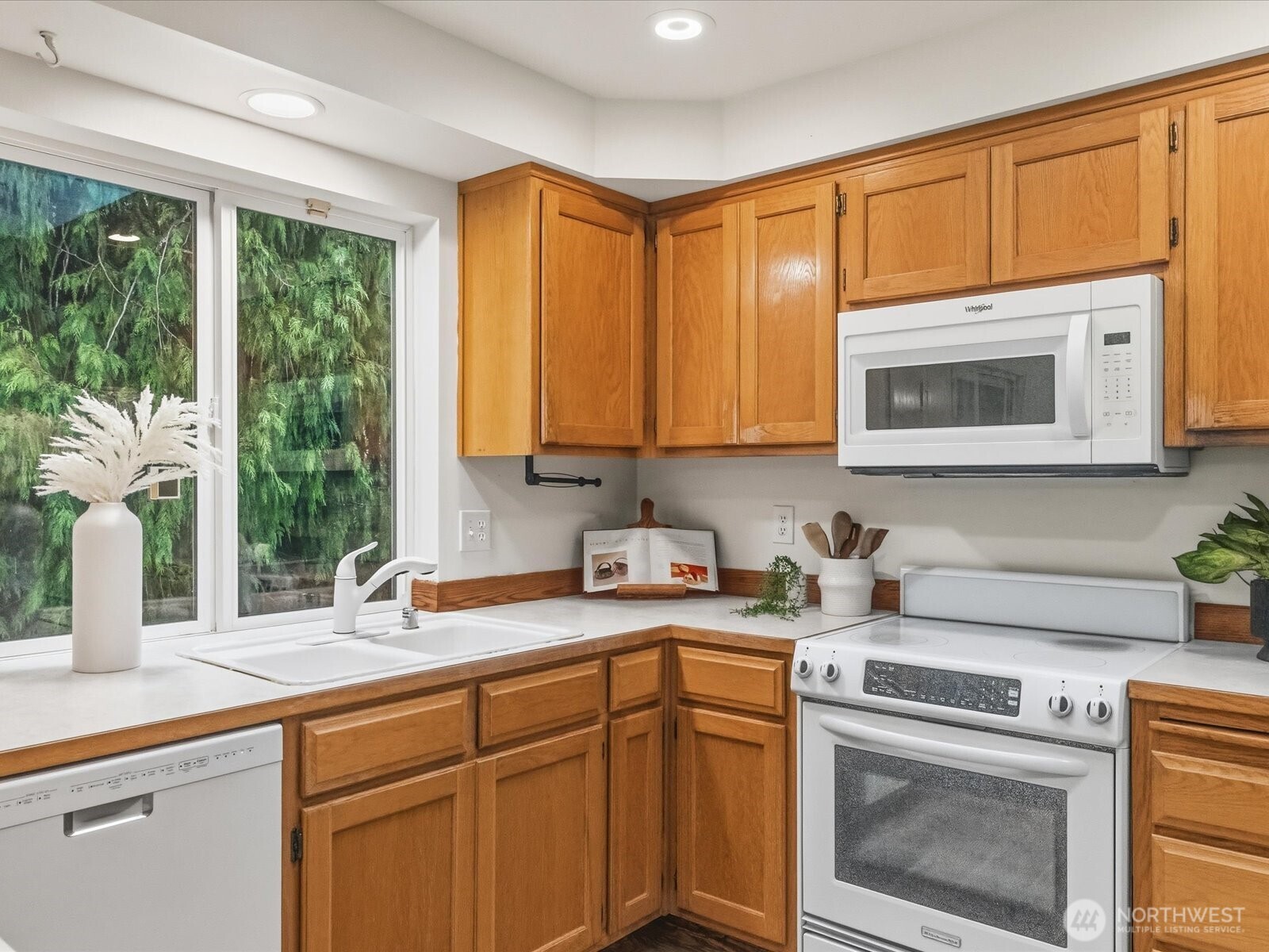3129 200th Place Southeast Bothell, WA 98012 - Photo 12 of 38 a kitchen with stainless steel appliances granite countertop white cabinets granite counter tops and a window