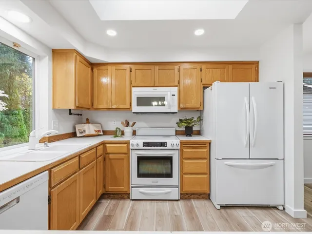 a kitchen with a white cabinets and refrigerator