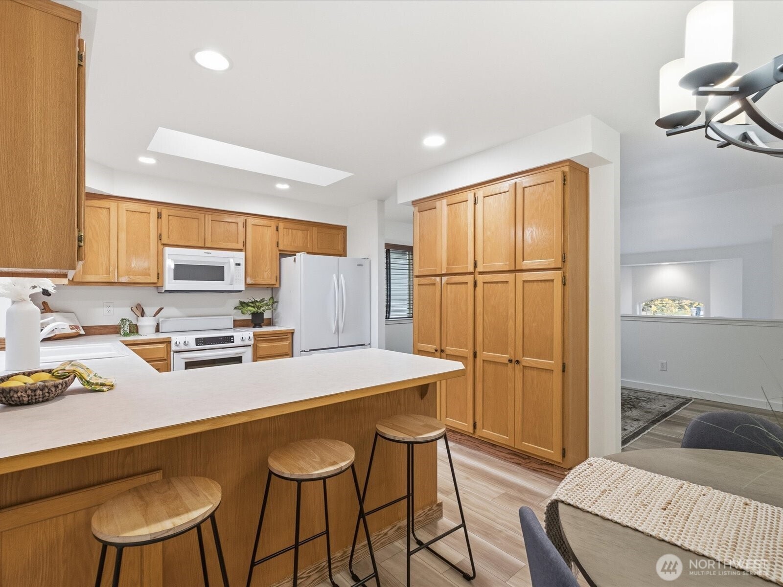3129 200th Place Southeast Bothell, WA 98012 - Photo 14 of 38 a kitchen with a table chairs refrigerator and cabinets