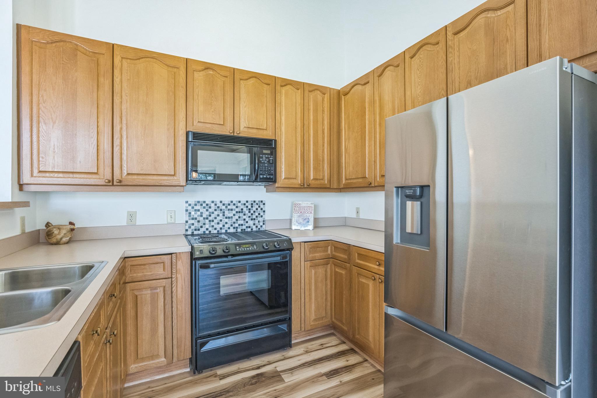 534 Runabout Loop, Unit 534 Solomons, MD 20688 - Photo 12 of 36 a kitchen with stainless steel appliances granite countertop a refrigerator stove and sink