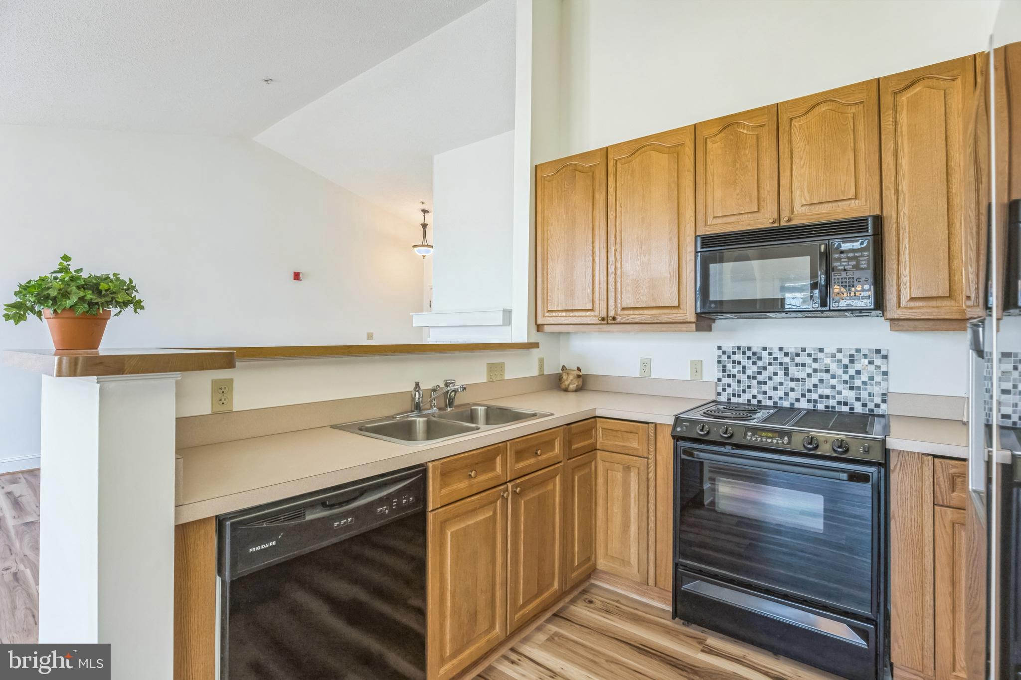 534 Runabout Loop, Unit 534 Solomons, MD 20688 - Photo 13 of 36 a kitchen with a sink stove and cabinets