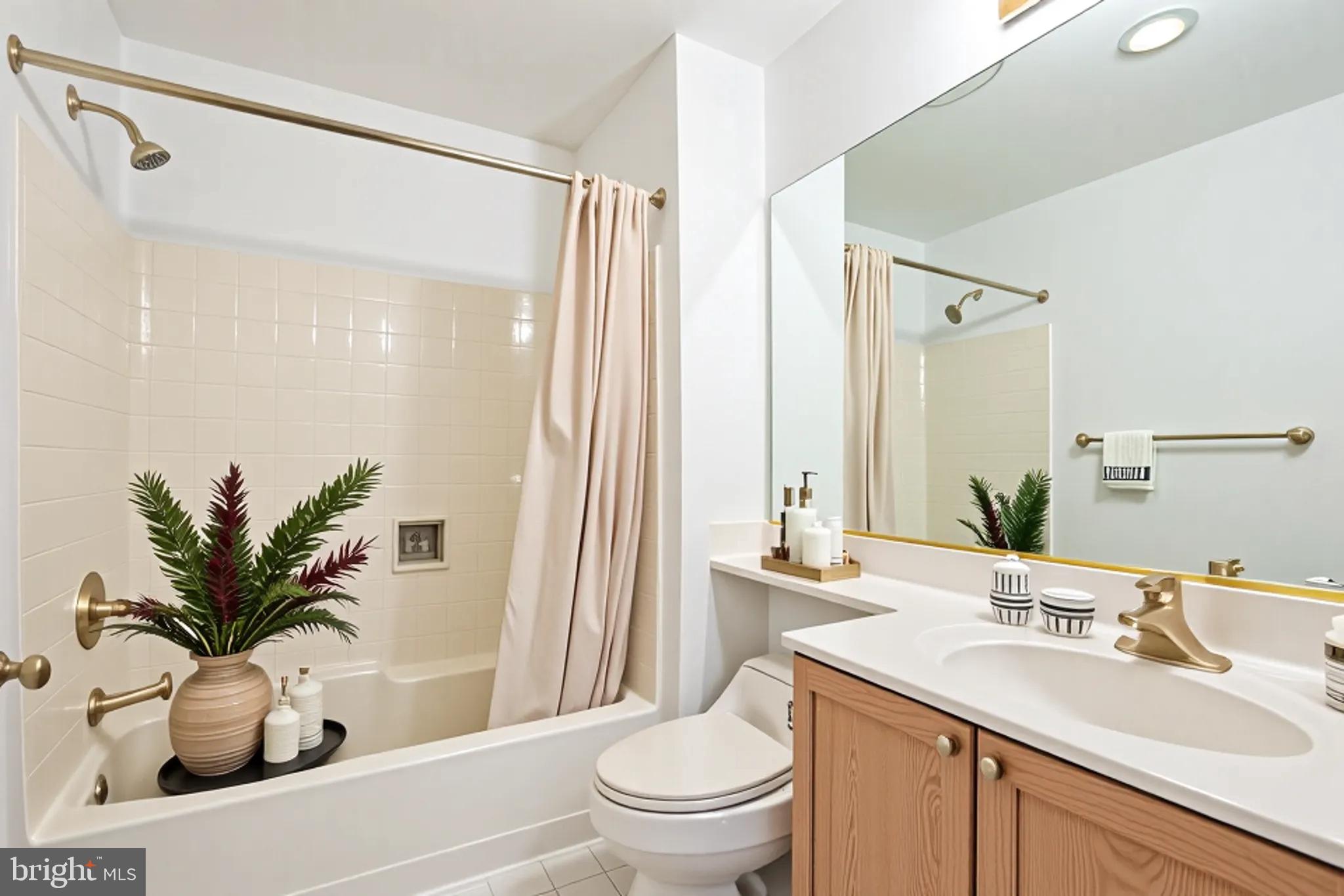 534 Runabout Loop, Unit 534 Solomons, MD 20688 - Photo 20 of 36 a bathroom with a sink a toilet and a large mirror