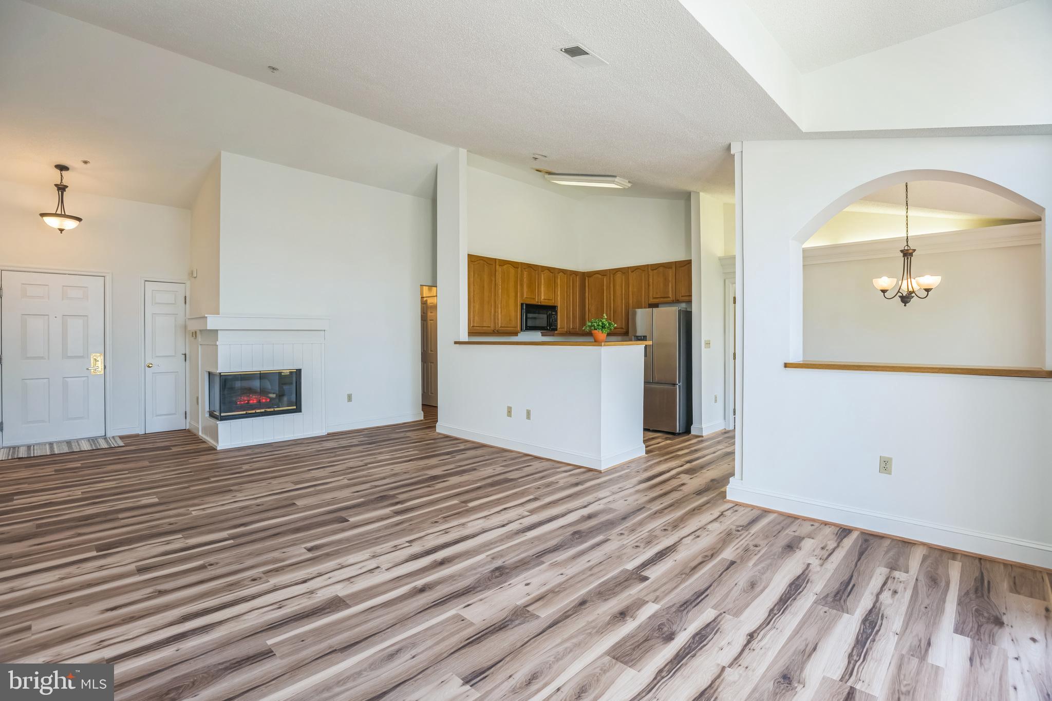 534 Runabout Loop, Unit 534 Solomons, MD 20688 - Photo 24 of 36 a view of a kitchen with wooden floor and a fireplace