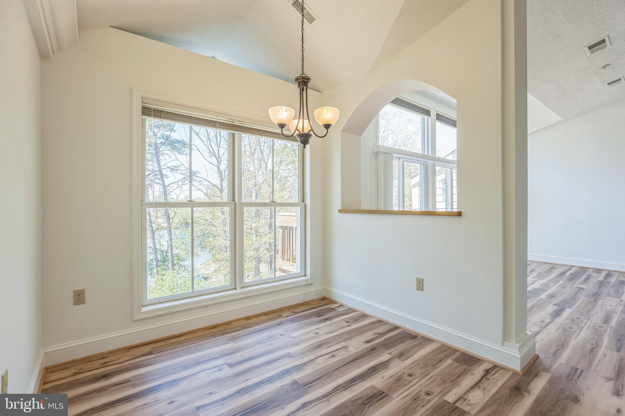 534 Runabout Loop, Unit 534 Solomons, MD 20688 - Photo 26 of 36 a view of empty room with wooden floor and fan