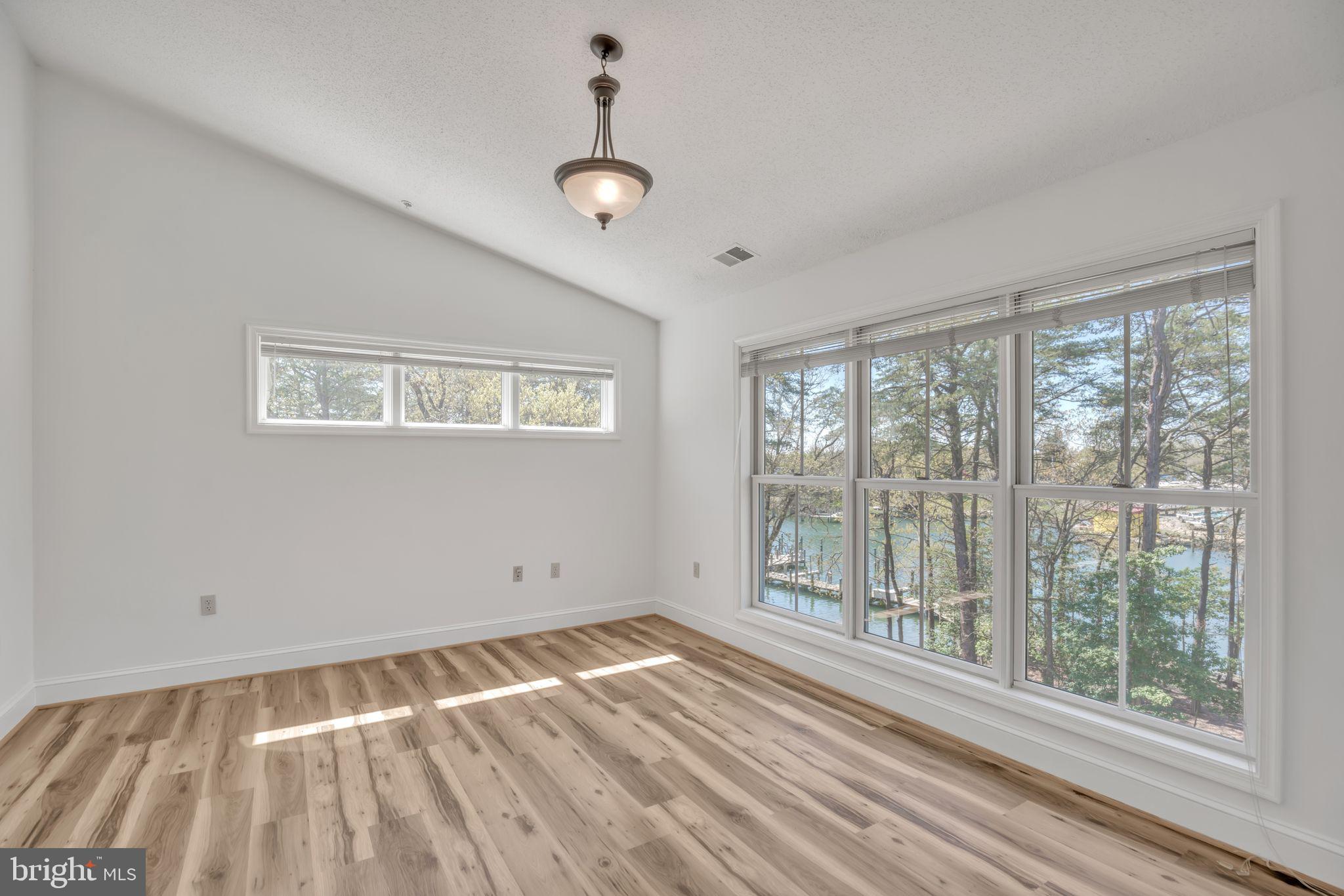 534 Runabout Loop, Unit 534 Solomons, MD 20688 - Photo 27 of 36 a view of empty room with wooden floor and fan