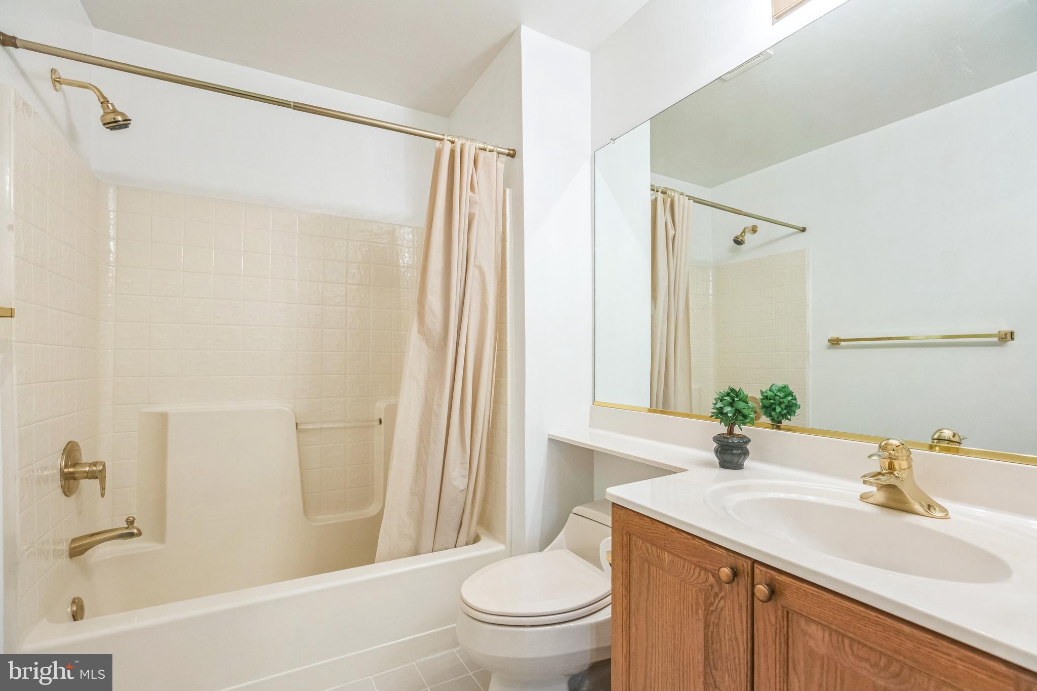 534 Runabout Loop, Unit 534 Solomons, MD 20688 - Photo 30 of 36 a bathroom with a sink a toilet and a bathtub