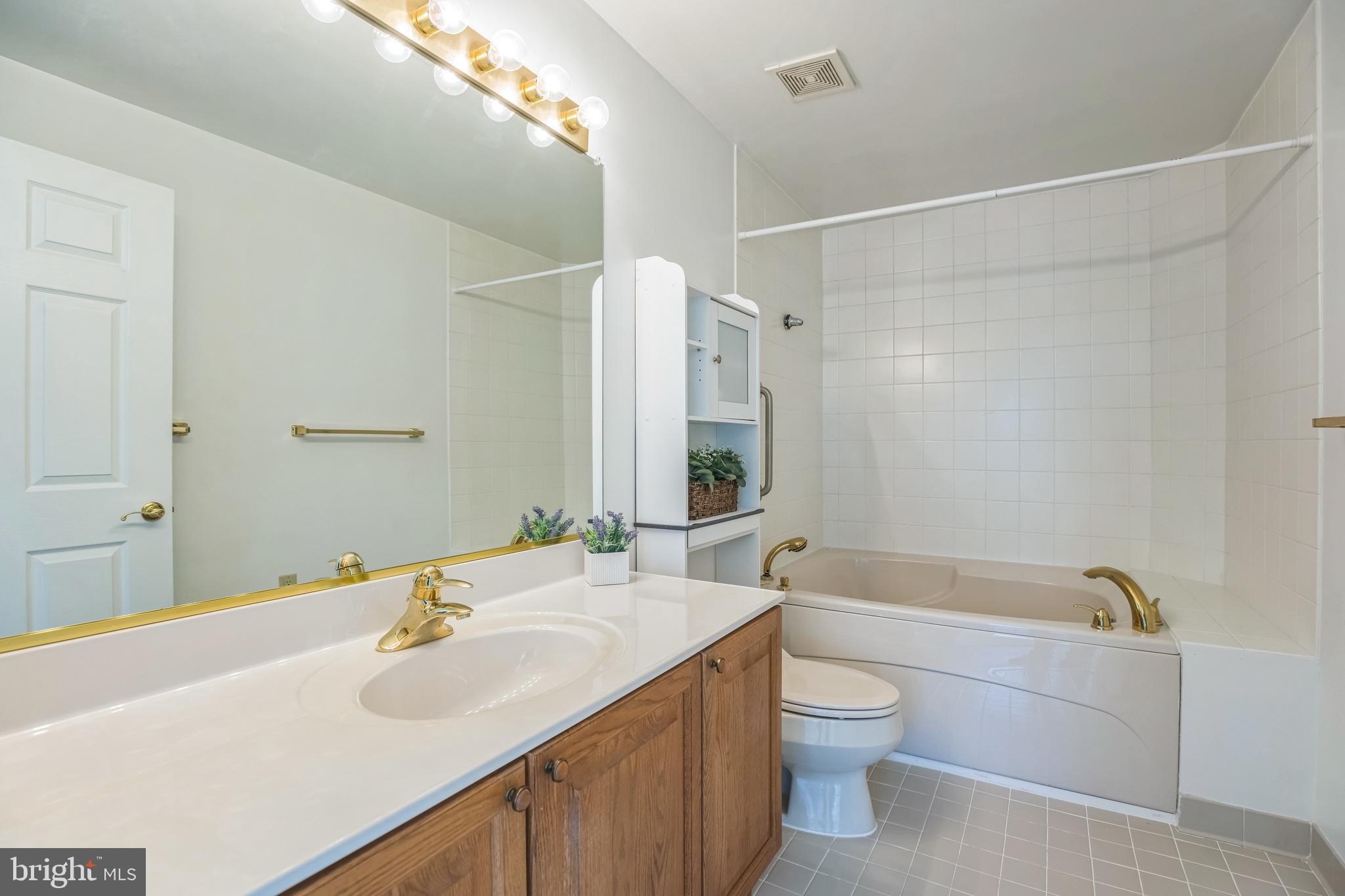 534 Runabout Loop, Unit 534 Solomons, MD 20688 - Photo 32 of 36 a bathroom with a sink a toilet and shower