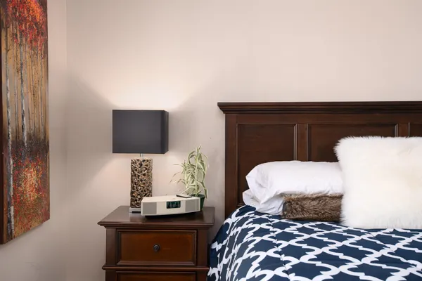 a bedroom with a bed and a flat screen tv