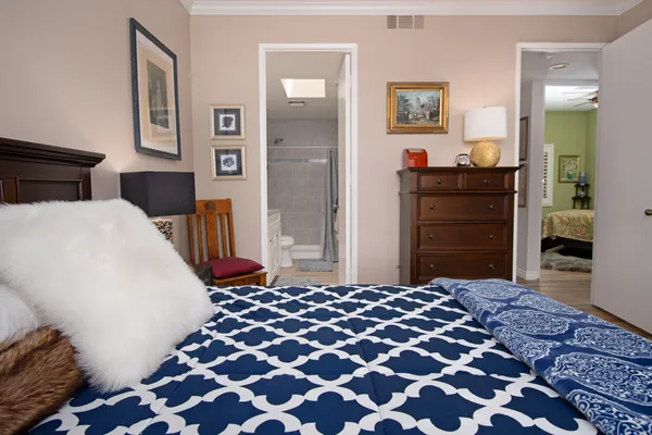 a bedroom with a bed and a dresser