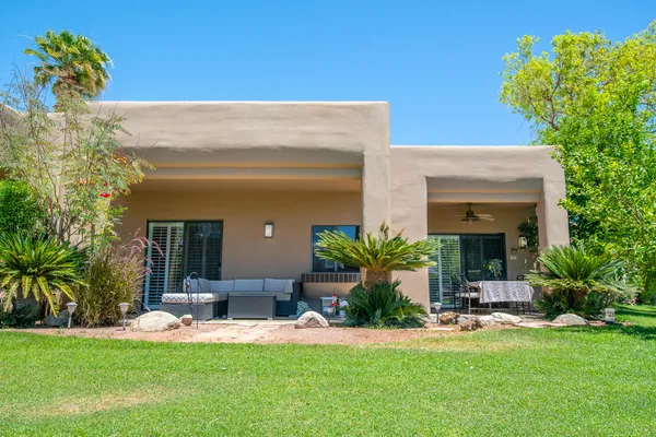 a view of an house with backyard space and palm tree