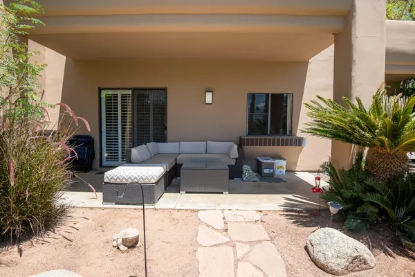 a outdoor space with patio the couch and potted plants