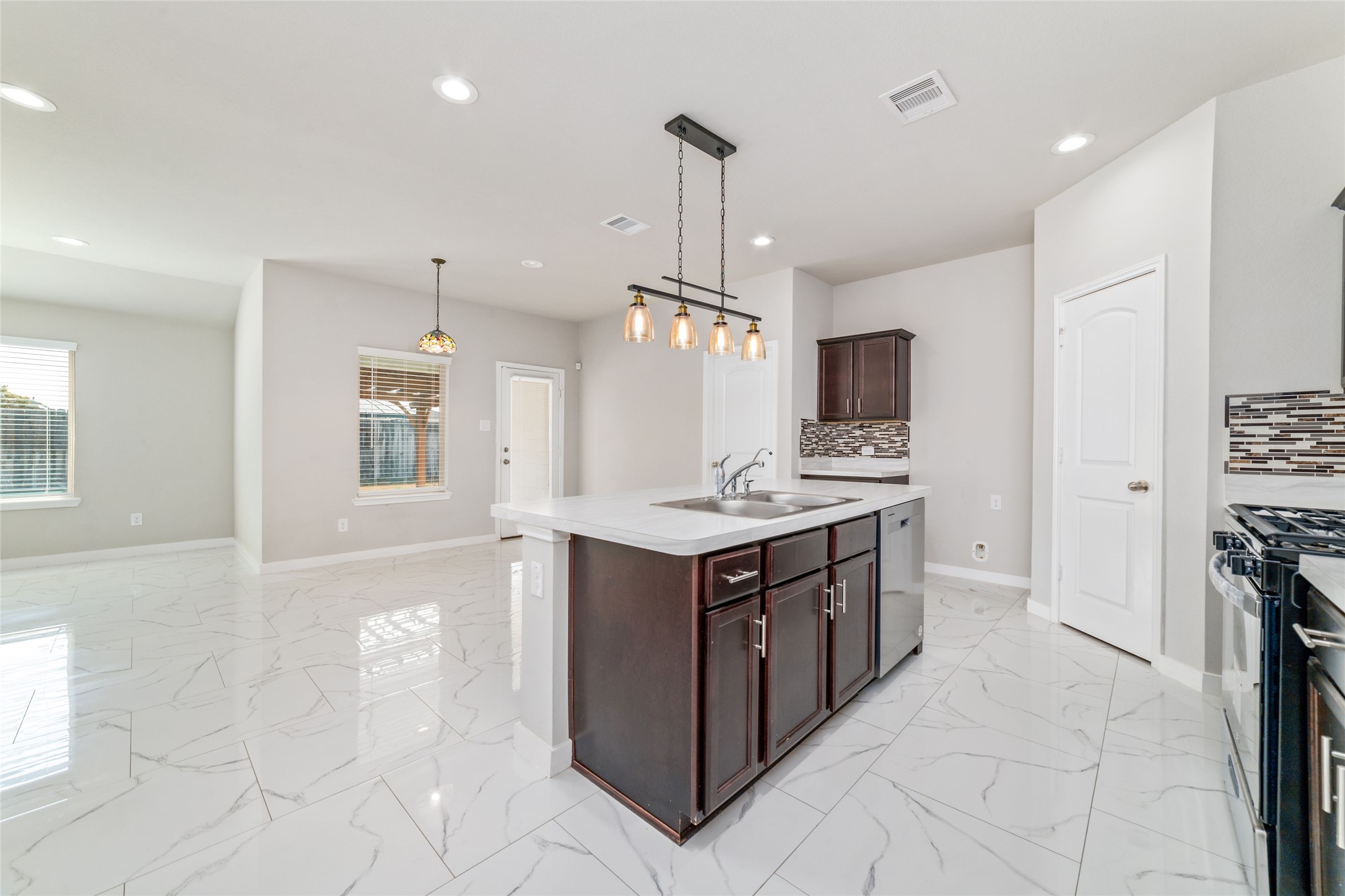 5502 Creekside Ridge Trail Katy, TX 77449 - Photo 8 of 25 a kitchen with stainless steel appliances granite countertop a sink and a stove